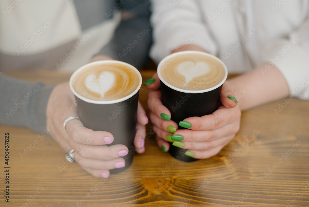 cups of coffee in female hands with heart symbol cups of coffee in female hands with heart symbol