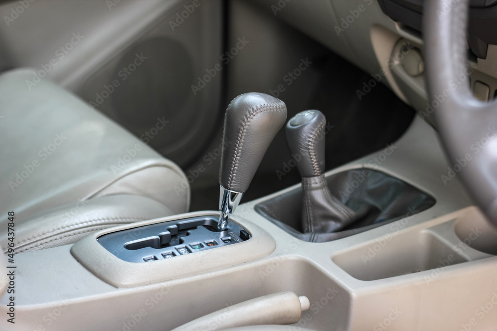 automatic transmission shift selector in the car interior. Closeup a manual shift of modern car gear shifter. 4x4 gear shift automatic transmission shift selector in the car interior. Closeup a manual shift of modern car gear shifter. 4x4 gear shift