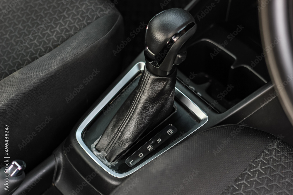 automatic transmission shift selector in the car interior. Closeup a manual shift of modern car gear shifter. 4x4 gear shift automatic transmission shift selector in the car interior. Closeup a manual shift of modern car gear shifter. 4x4 gear shift
