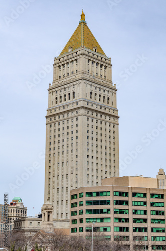 Thurgood Marshall United States Courthouse Tower with yellow roof and building with green windows in the forefront, New York City, overcast, vertical photo