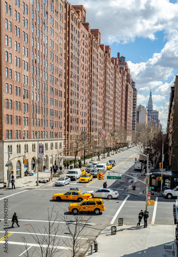 Fotografering Crossroads at Chelsea, New York City with lots of yellow taxi cabs and cars pass