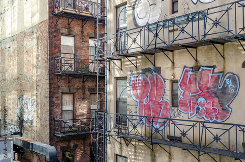 Wall Mural Rustic Residential Building Facade in Chelsea with Graffiti on the Wall, Emergen