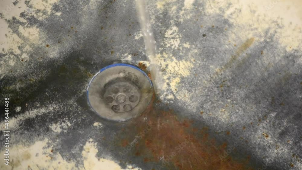Very old rusty shabby bath closeup. A bath with peeling white enamel