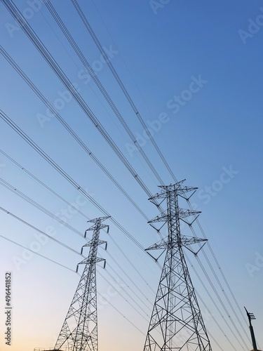Electric tower on blue sky and clounds as a background, High voltage tower in large construction site, Space for text in template,