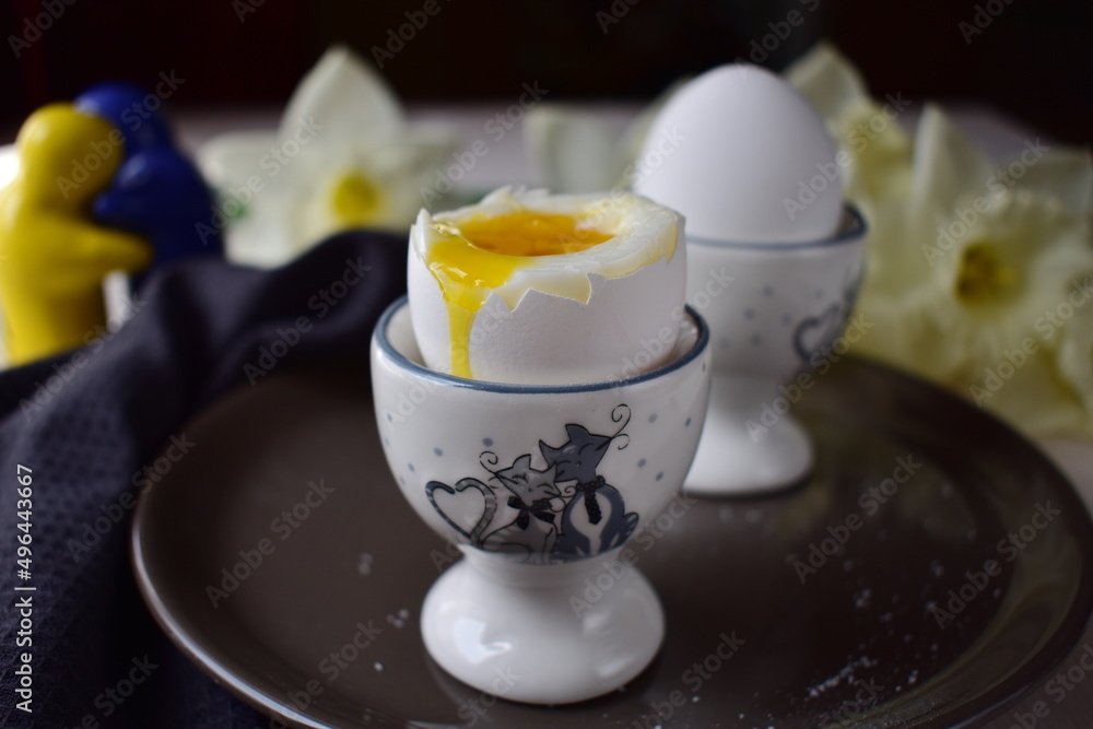 boiled eggs in egg cups on a brown plate boiled eggs in egg cups on a brown plate