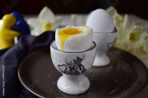 boiled eggs in  egg cups on a brown plate