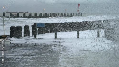 Sea waves on pier during storm called Corrie, Vlissingen, Netherlands photo