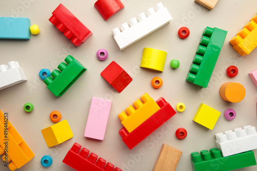 Multicolored blocks of the children s constructor lie on grey background.