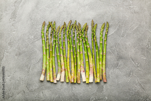 Bunch of green asparagus on concrete background. Top view