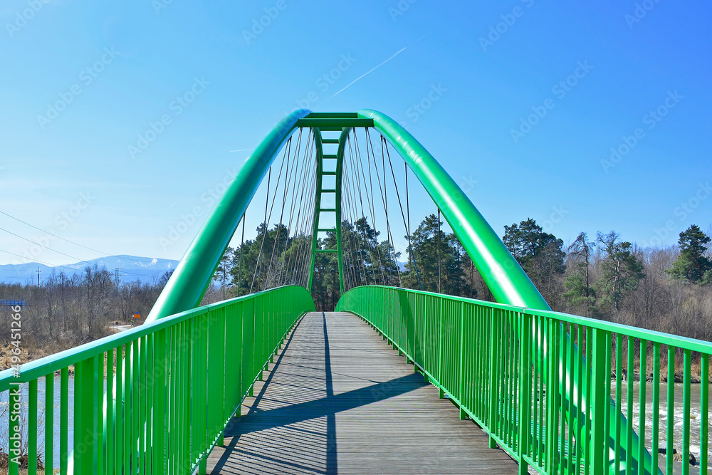 Modern architecture cycling path. Green bridge  for bikers and pedestrians over Poprad river in Stary Sacz, Poland.  Velo Dunajec cycling road.
