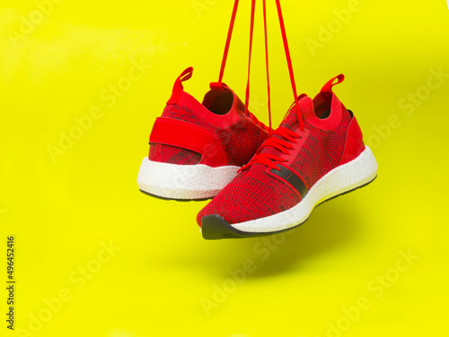 Red sneakers isolated on the yellow background