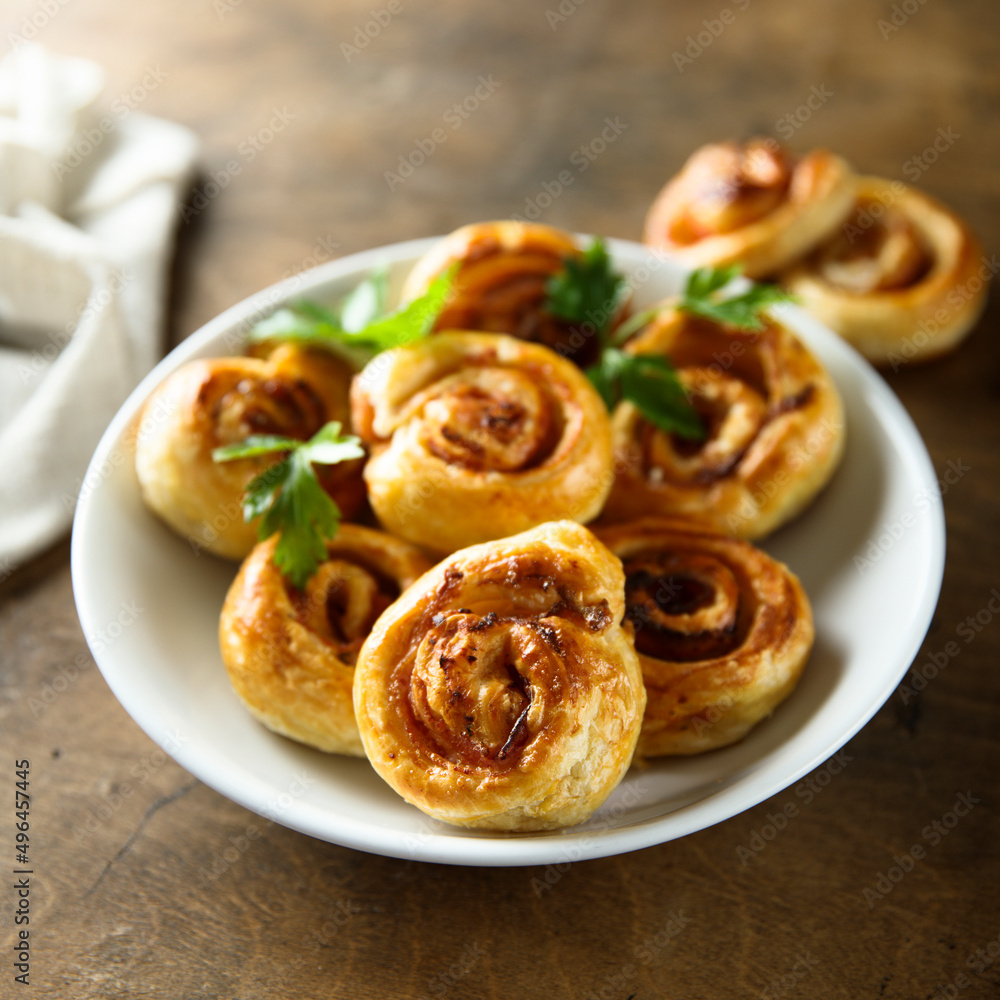 Homemade puff pastry swirls with bacon and tomato Homemade puff pastry swirls with bacon and tomato
