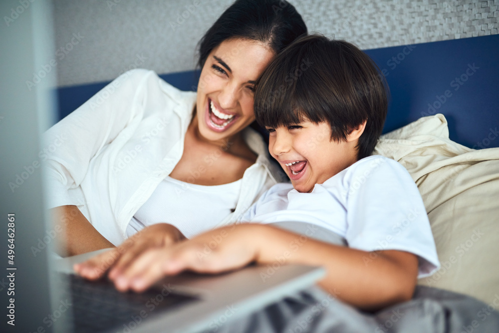 Theres so much entertainment to be found online. Shot of a mother and her little son using a laptop together at home. Theres so much entertainment to be found online. Shot of a mother and her little son using a laptop together at home.