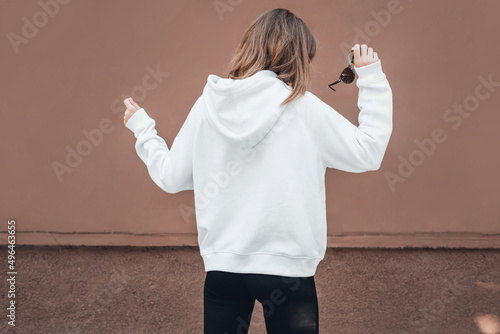 Woman in white hoodie, back view, mockup.