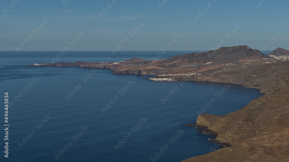 Aerial panoramic view over the northwestern coast of island Gran Canaria, Canary Islands, Spain with village Puerto de las Nieves with mountains.