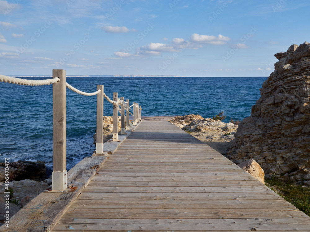 Landscape of the Mediterranean sea in the Balearic Islands, with a wooden pier in Palmanova, Calviá, Majorca, Spain, Europe Landscape of the Mediterranean sea in the Balearic Islands, with a wooden pier in Palmanova, Calviá, Majorca, Spain, Europe