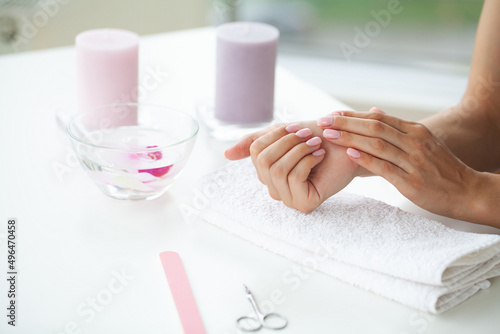 Happy woman making manicure when resting at home