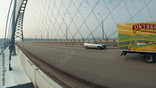 traffic on a transport bridge in siberia on a winter day