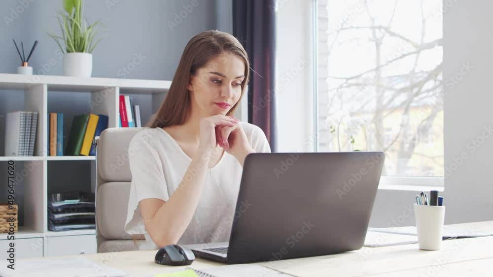 Young Woman Works at Home Office Using Computer. Workplace of Female Entrepreneur, Freelancer or Student. Remote Work and Education Concept. Young Woman Works at Home Office Using Computer. Workplace of Female Entrepreneur, Freelancer or Student. Remote Work and Education Concept.