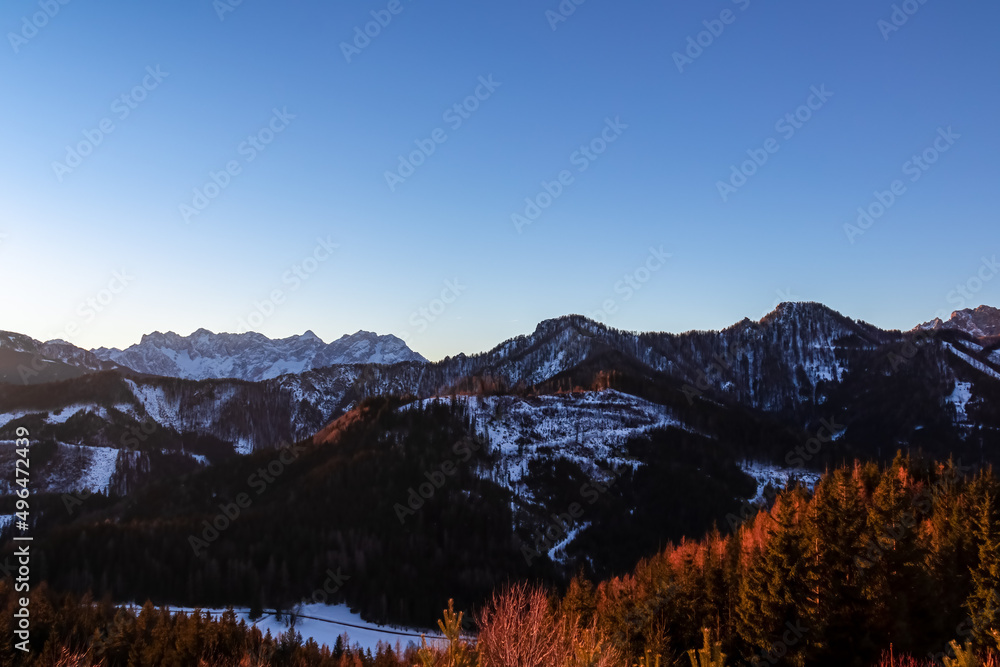 Early morning view on snow capped mountain peaks of Karawanks in Carinthia, Austria. Julian Alps. Scenic view on winter wonderland in the Austrian Alps, Europe. Ski tour, snow shoe hiking. Hochobir