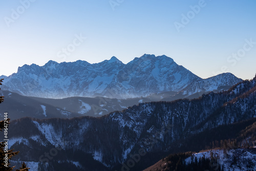 Early morning view on snow capped mountain peaks of Karawanks in Carinthia  Austria. Julian Alps. Scenic view on winter wonderland in the Austrian Alps  Europe. Ski tour  snow shoe hiking. Grintovec