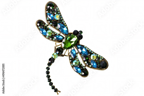 A red and blue dragonfly jewelry on white background, isolated.