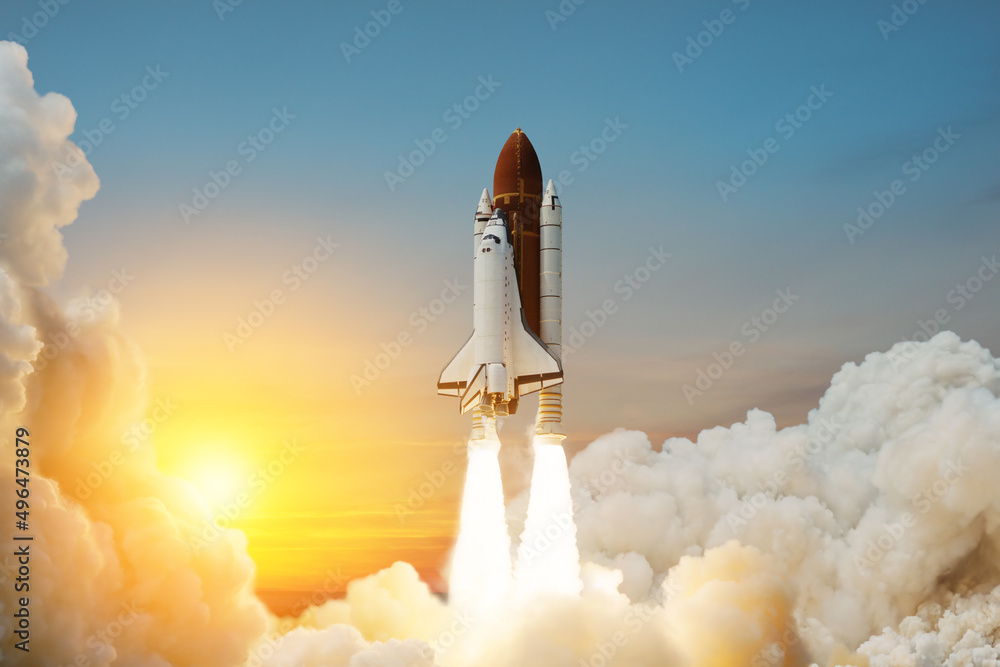 Obraz premium Spaceship lift off. Space shuttle with smoke and blast takes off into space on a background of sunset. Successful start of a space mission. Travel to Mars. Elements of this image furnished by NASA.