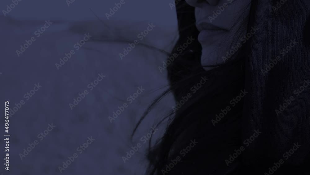the wind blows the woman's hair in profile. lips and hair close-up night shooting the wind blows the woman's hair in profile. lips and hair close-up night shooting