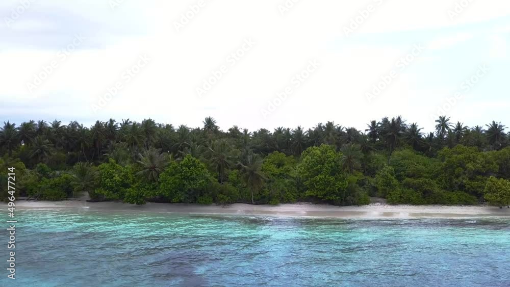 Dream trip to green island. Many coconut palms, white sand and blue water. Outdoor adventure travel to beautiful Hawaii beach. Cinematic wild nature aerial 4K. Waves of transparent green sea waters Dream trip to green island. Many coconut palms, white sand and blue water. Outdoor adventure travel to beautiful Hawaii beach. Cinematic wild nature aerial 4K. Waves of transparent green sea waters