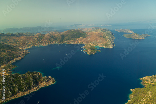 Trees burnt in forest fires of July 2021 in Marmaris resort town of Turkey from helicopter. Aerial view of Beautiful blue bays ans sea © Birol