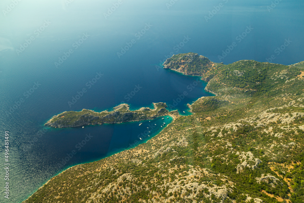 Trees burnt in forest fires of July 2021 in Marmaris resort town of Turkey from helicopter. Beautiful blue bays ans sea