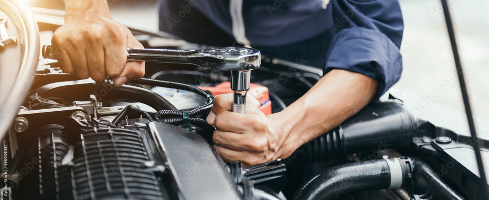 Automobile mechanic repairman hands repairing a car engine automotive workshop with a wrench, car service and maintenance,Repair service. Automobile mechanic repairman hands repairing a car engine automotive workshop with a wrench, car service and maintenance,Repair service.