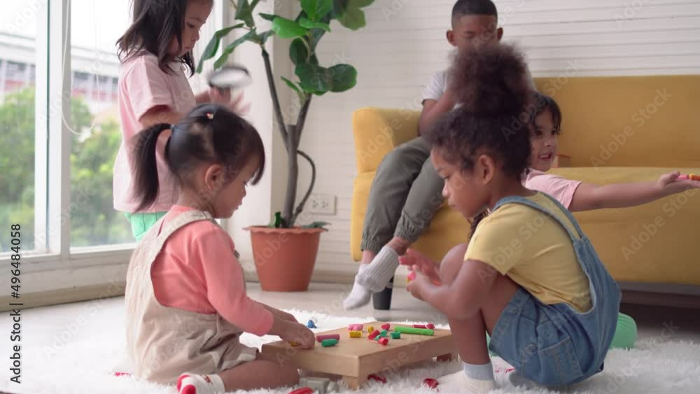 Children playing toy and game in living room, Group of friends, Little girls and boy mould from plasticine on the floor
Children playing toy and game in living room, Group of friends, Little girls and boy mould from plasticine on the floor