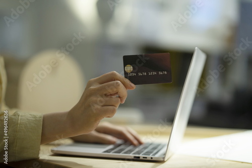 Close up of woman shopping online with credit card