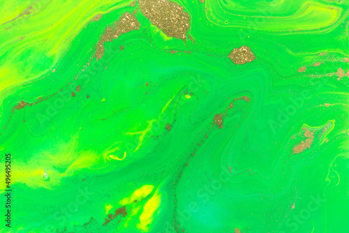 Gold spots on flow green vivid paints background. Abstract print