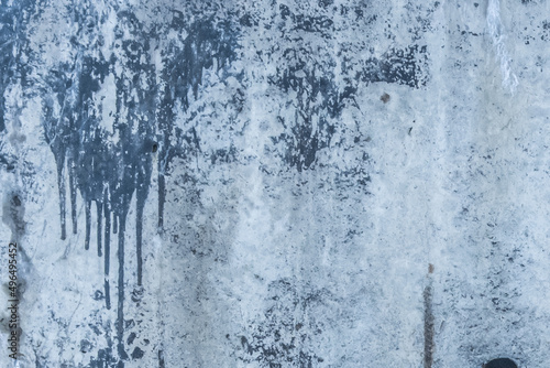 Blue painted concrete surface old stained paint wall texture spilled cement streaks background