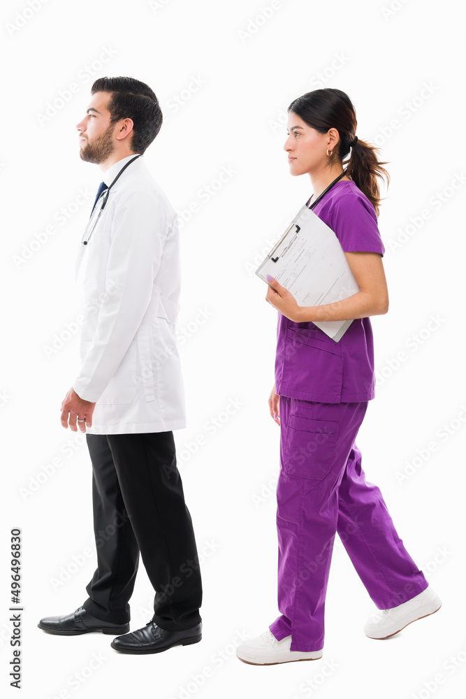 Hispanic doctor checking on a patient with a nurse Hispanic doctor checking on a patient with a nurse