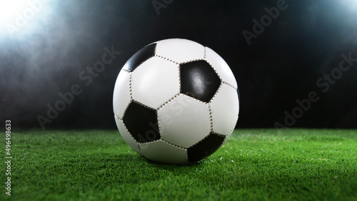 Soccer ball on grass with dark background and lights © Jag_cz