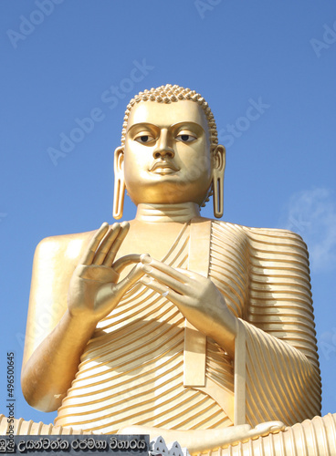 19th century golden Buddha  3o m tall  above the Golden Temple at Dambulla  near Dambulla Temple Complex in Sri Lanka. The posture is DharmaChakra Mudra  Wheel of Dharma   the Teaching Buddha .