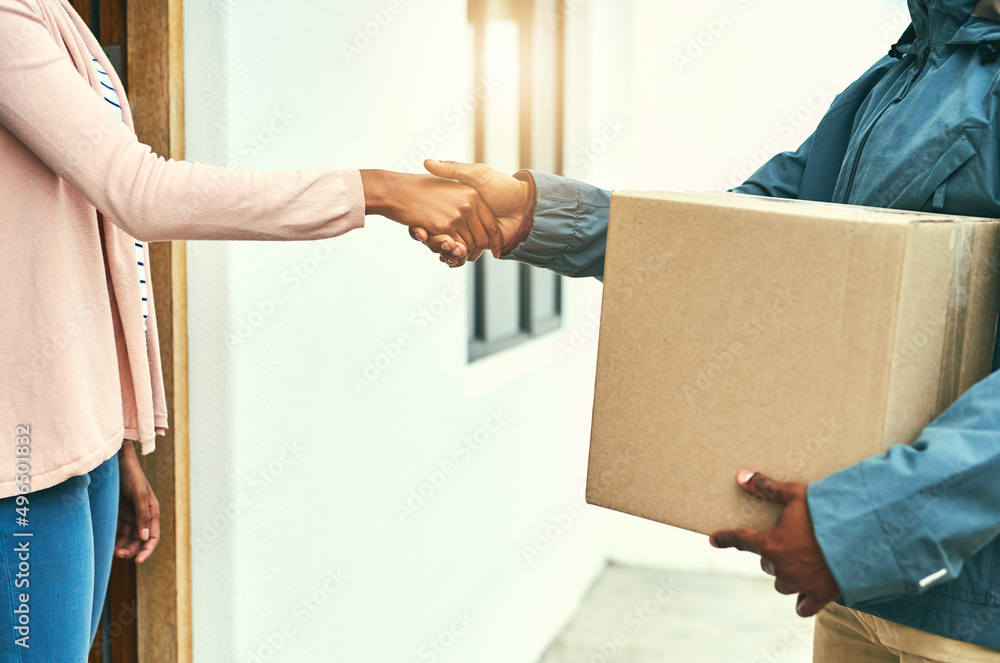 Our customers are always grateful for our speedy service. Closeup shot of a courier shaking hands with a customer while making a delivery. Our customers are always grateful for our speedy service. Closeup shot of a courier shaking hands with a customer while making a delivery.