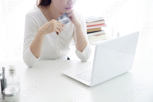 Young woman shopping online with credit card