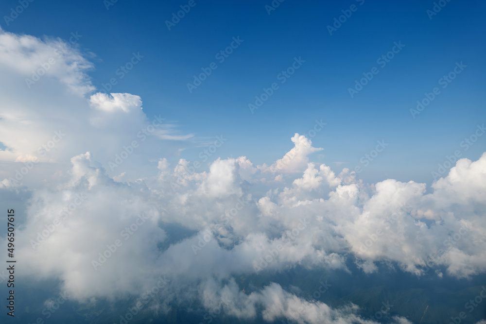 Aerial view clouds and blue sky from airplane window Aerial view clouds and blue sky from airplane window