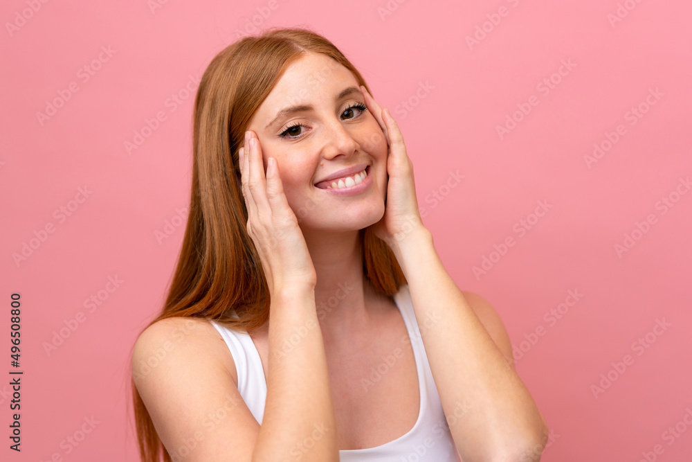 Young redhead woman isolated on pink background Young redhead woman isolated on pink background