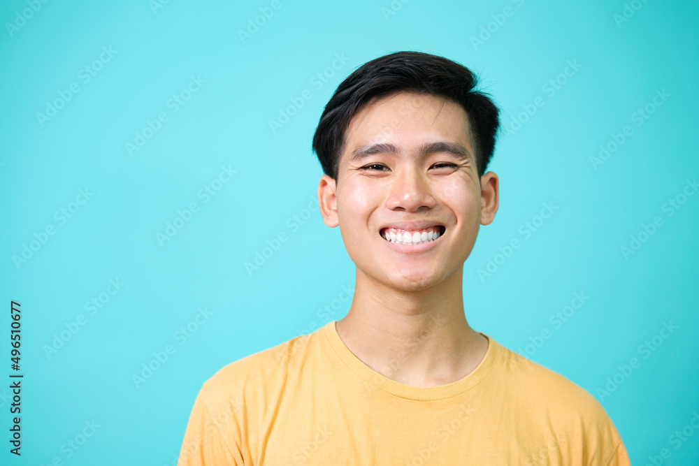 Close up portrait of young smiling handsome guy in yellow t-shirt isolated background. Close up portrait of young smiling handsome guy in yellow t-shirt isolated background.