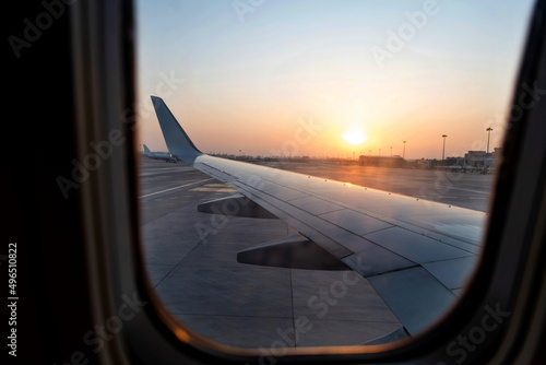 View on sunset and airplane wing from the inside