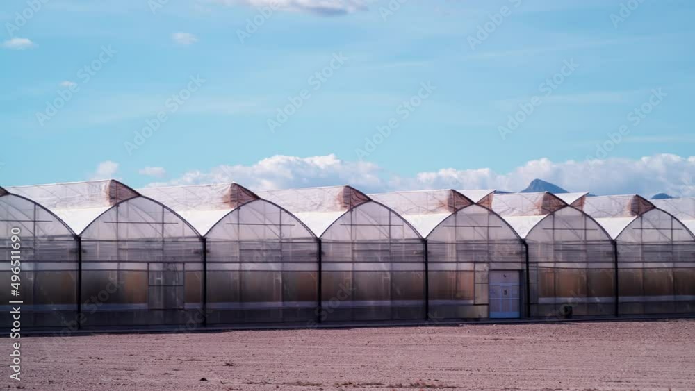 Spanish coast landscape with big commercial glass greenhouses. Industrial agriculture. Murcia region, Spain. Dolly shot Spanish coast landscape with big commercial glass greenhouses. Industrial agriculture. Murcia region, Spain. Dolly shot