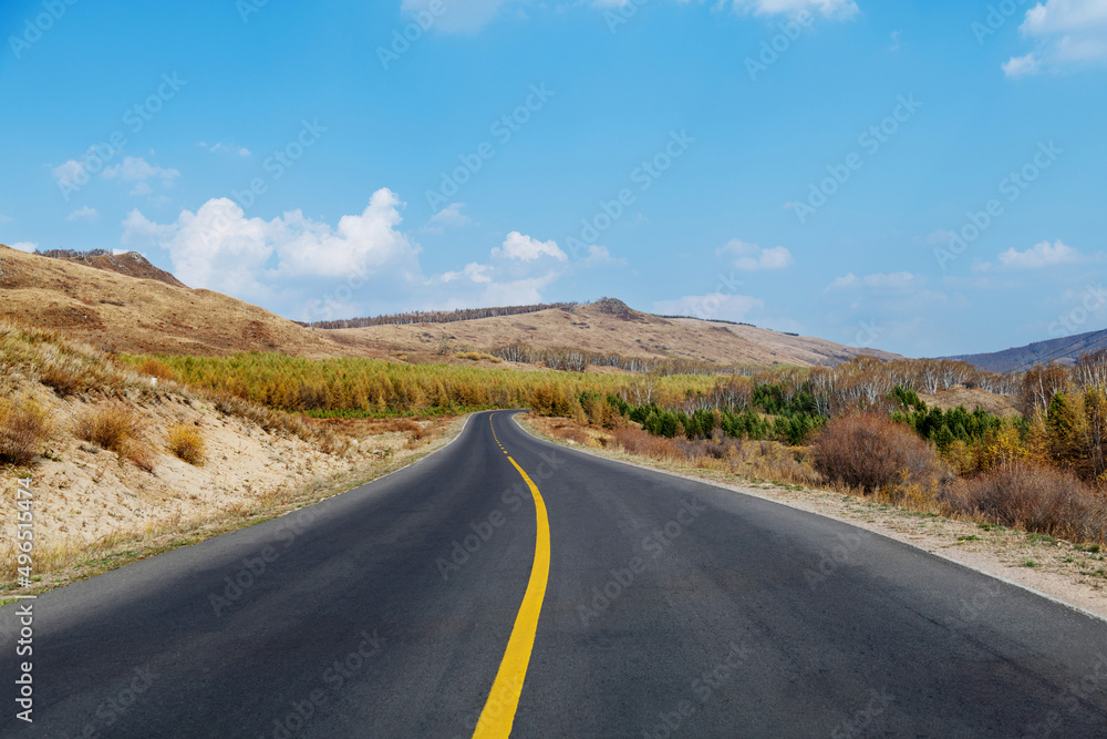 Country road through the hill in the autumn
