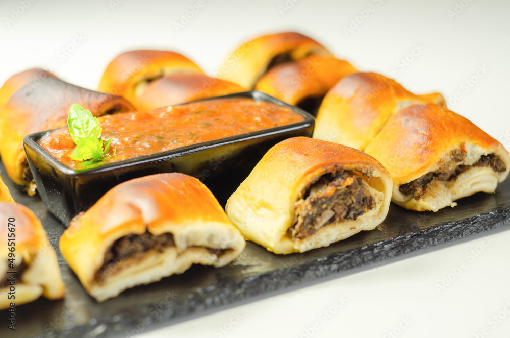 Patty's pies stuffed with minced meat, mushrooms and onion, served with sauce Patty's pies stuffed with minced meat, mushrooms and onion, served with sauce