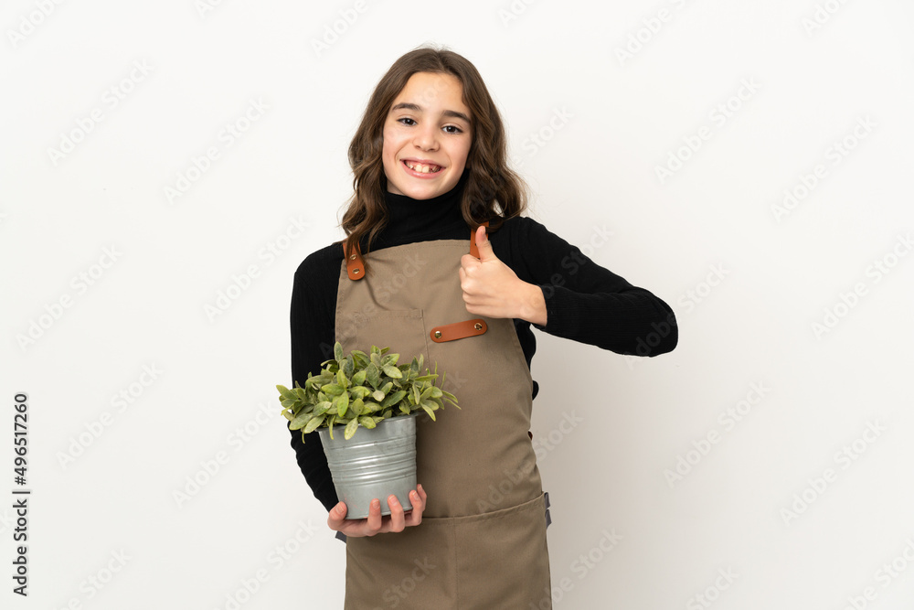 Little girl holding a plant isolated on white background giving a thumbs up gesture Little girl holding a plant isolated on white background giving a thumbs up gesture
