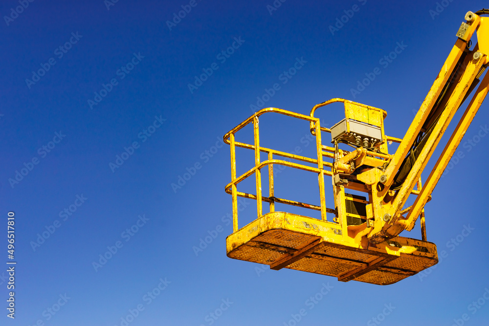 Basket lift, lifting platform on construction site. Basket lift, lifting platform on construction site.